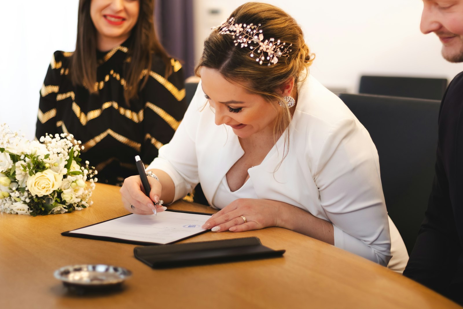 Both parents signing a travel consent letter before a notary