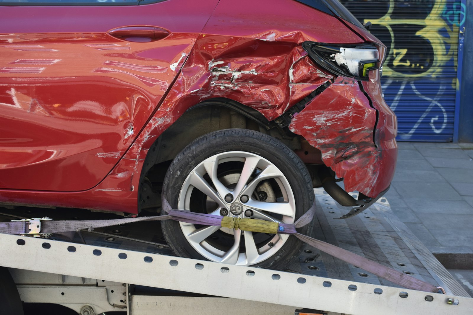 A totaled vehicle being collected by the insurer